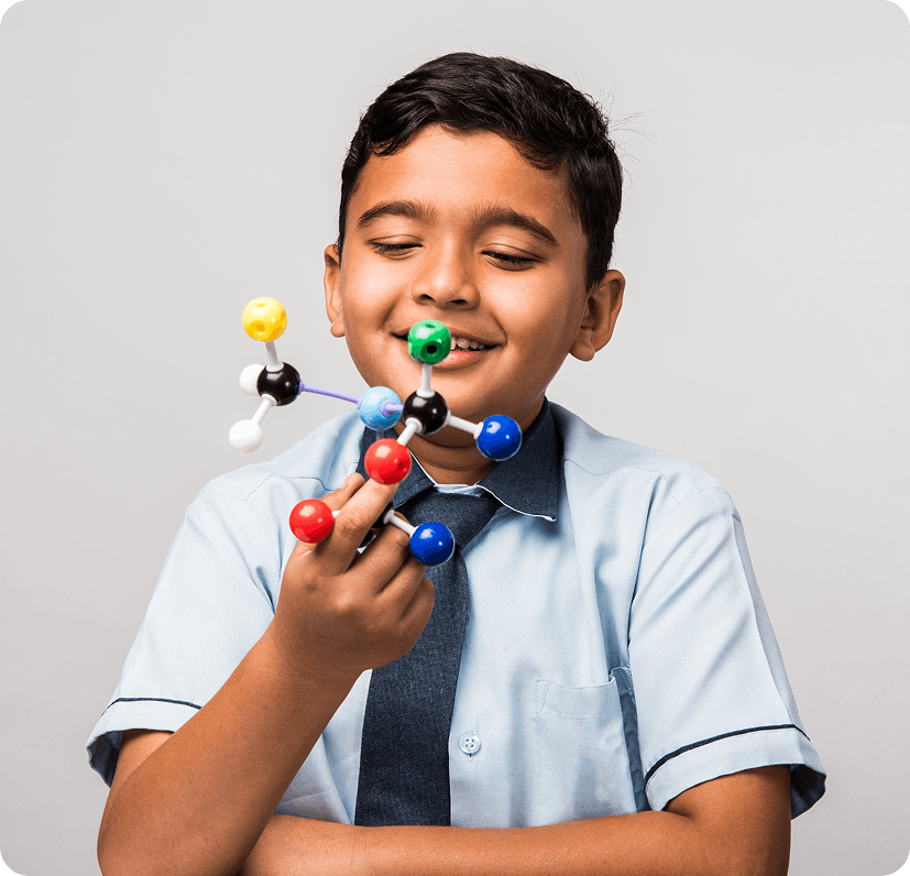indian-school-kid-science-student-using-molecular-model-kit-studying-physics-selective-focus-1.png
